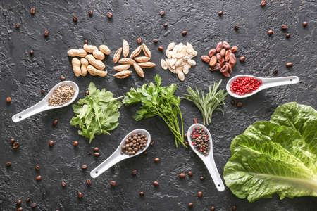 Different herbs, nuts and spices on dark backgroundの写真素材