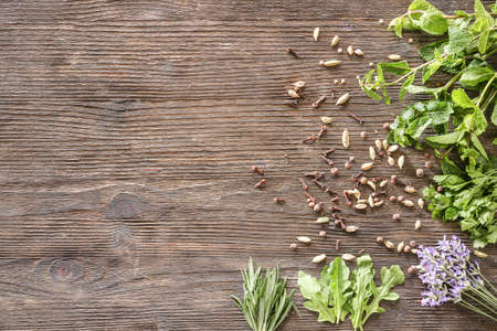 Different herbs and spices on wooden background