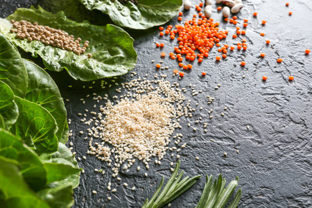 Different herbs, legumes and spices on dark backgroundの写真素材