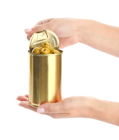 Female hands holding tin can with olives on white backgroundの写真素材