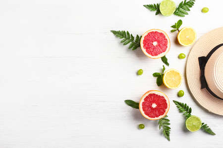 Summer composition with hat and tropical fruits on white wooden backgroundの写真素材