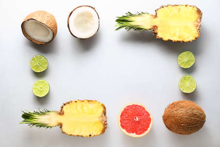 Frame made of different fruits on light backgroundの写真素材