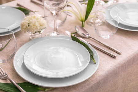 Beautiful festive table setting with flowers