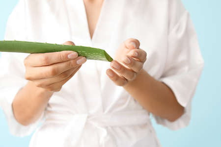 Beautiful young woman with aloe vera, closeupの写真素材