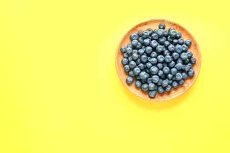 Plate with fresh blueberry on color backgroundの写真素材