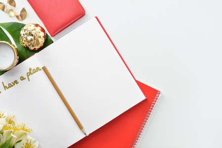 Notebooks, flowers and decor on white backgroundの写真素材