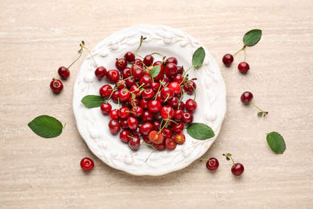 Plate with ripe cherry on tableの写真素材