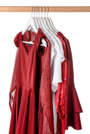 Rack with hanging clothes on white backgroundの写真素材