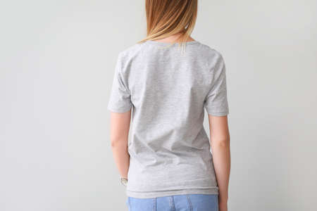 Woman in stylish t-shirt on light background, back viewの写真素材