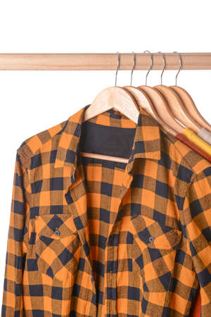 Rack with hanging clothes on white backgroundの写真素材