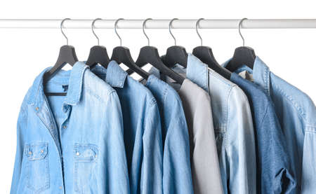 Rack with hanging clothes on white backgroundの写真素材