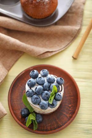 Tasty blueberry cake on wooden table