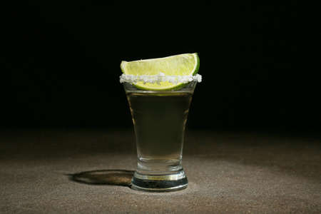 Shot of tequila on dark background