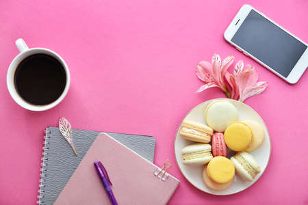 Composition with stationery, mobile phone, dessert and cup of coffee on color backgroundの写真素材