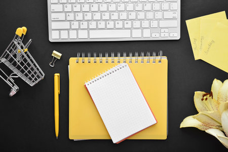 Composition with stationery and computer keyboard on dark background
