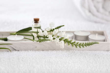 Flowers and spa items on table in beauty salon