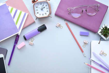 Composition with stationery and alarm clock on gray backgroundの写真素材