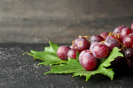 Ripe sweet grapes on dark tableの写真素材