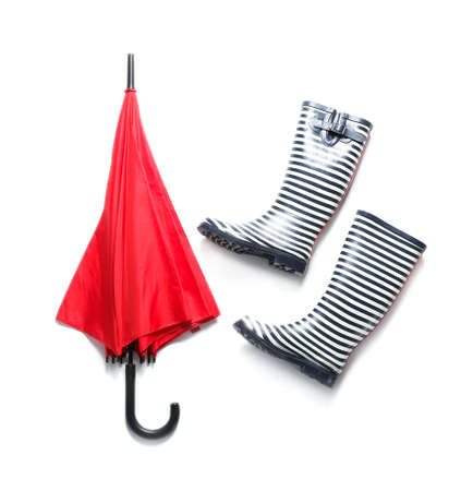 Stylish umbrella with gumboots on white backgroundの写真素材