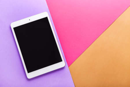 Modern tablet computer on color backgroundの写真素材