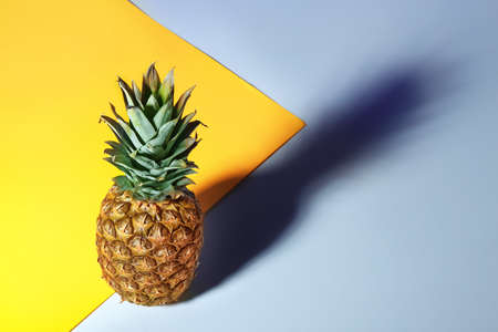 Tasty ripe pineapple on color backgroundの写真素材