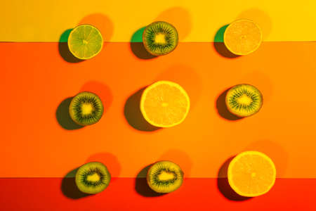 Tasty cut fruits on color backgroundの写真素材