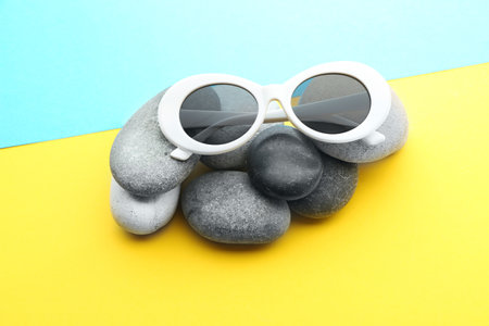Stylish sunglasses with stones on color backgroundの写真素材