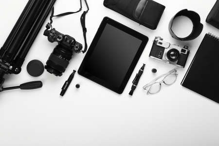Tablet computer and set of photographer's equipment on white backgroundの写真素材