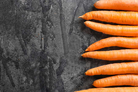 Tasty fresh carrot on dark backgroundの写真素材