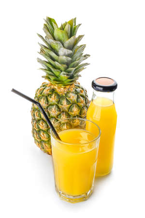 Glass and bottle of tasty pineapple juice on white backgroundの写真素材