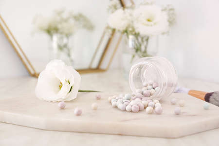 Jar with powder pearls on boardの写真素材