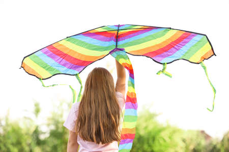 Little girl flying kite outdoors