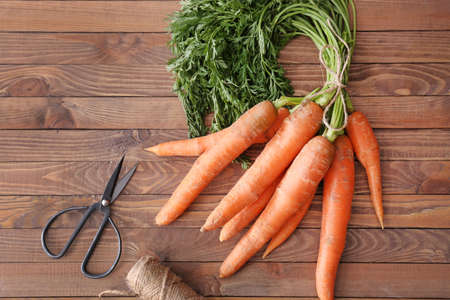 Bunch of carrots on wooden table