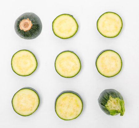 Composition with fresh cut zucchini on white backgroundの写真素材