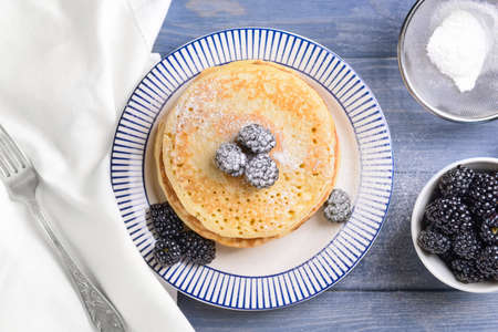 Tasty pancakes with berries on tableの写真素材