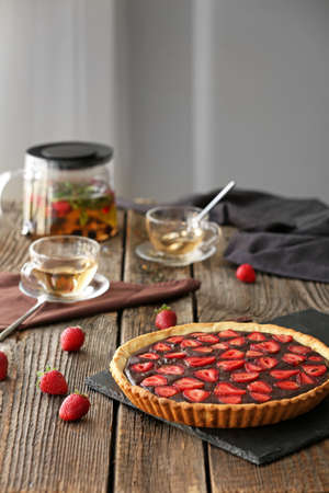 Tasty chocolate cake with strawberry on wooden tableの写真素材