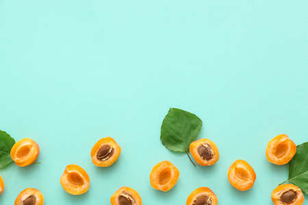Tasty cut apricots on color backgroundの写真素材