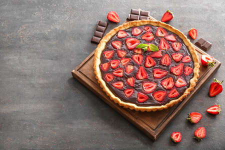Tasty chocolate cake with strawberry on tableの写真素材