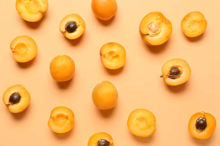 Tasty apricots on color backgroundの写真素材