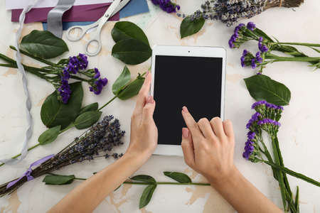 Female florist with tablet computer at workplaceの写真素材