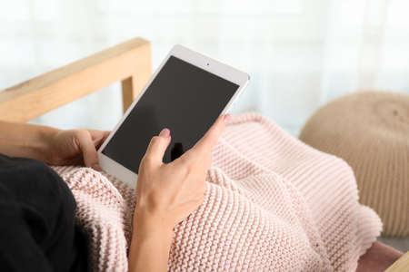 Woman using tablet computer, closeup