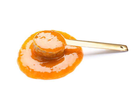 Scoop with tasty apricot jam on white backgroundの写真素材