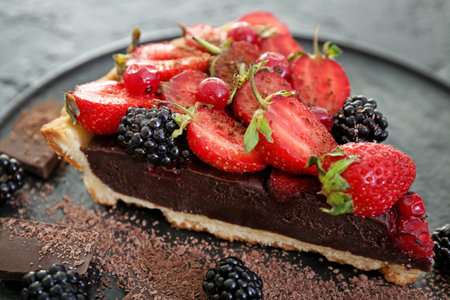 Piece of tasty chocolate strawberry cake on plate, closeupの写真素材