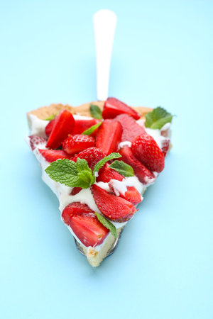 Piece of tasty strawberry cake on color background