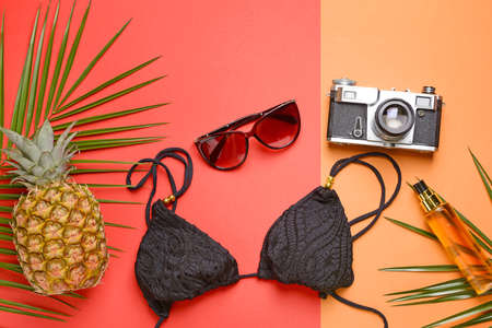 Composition with beach accessories and photo camera on color backgroundの写真素材