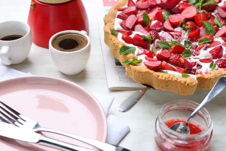 Tasty strawberry cake with coffee on tableの写真素材