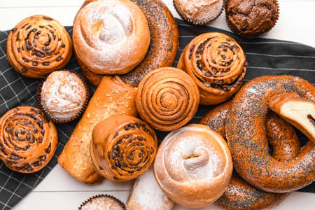 Heap of tasty pastries on white wooden backgroundの写真素材