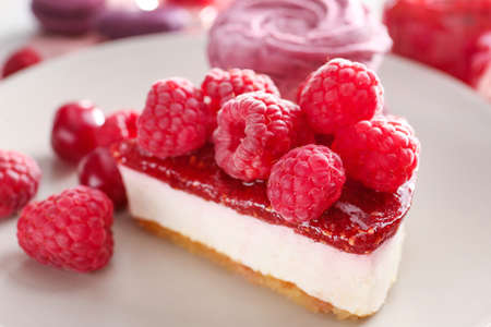 Tasty raspberry cheesecake on plate, closeup