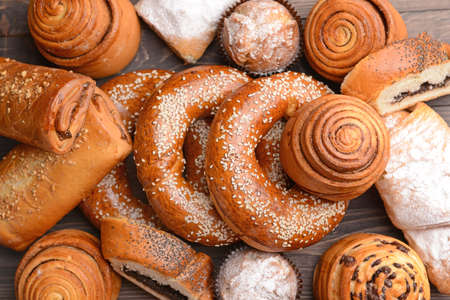 Heap of tasty pastries on wooden backgroundの写真素材