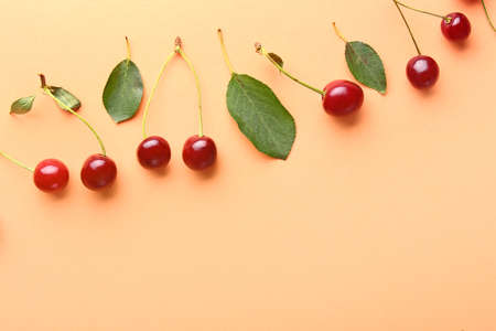 Many ripe sweet cherry on color background